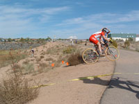 Cyclocross racers ride through dry terrain