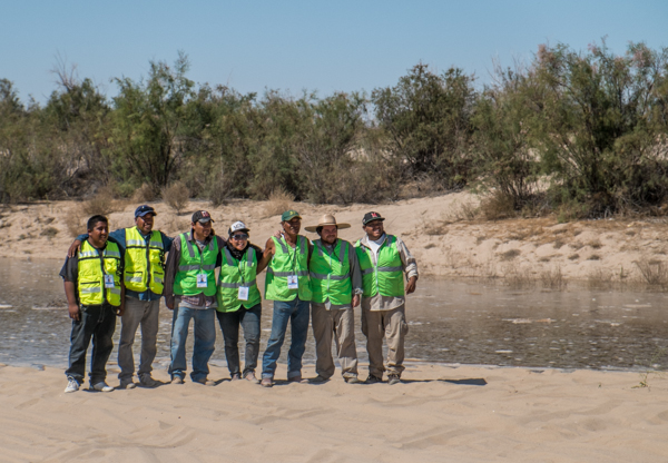 Osvel Hinojosa (second from right, in broad-brimmed hat) and crew as the pulse flow approaches San Luis, March 25, 2014