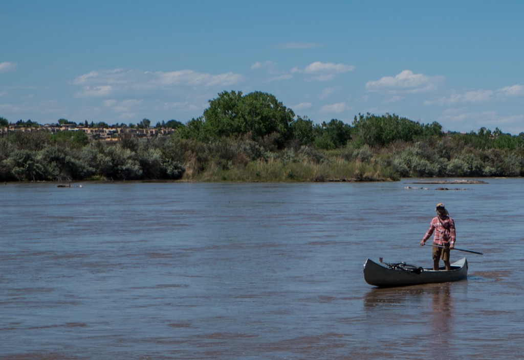 Guy with canoe, bicycle,  trailer, on the high flow of the Rio Grande, May 10, 2014